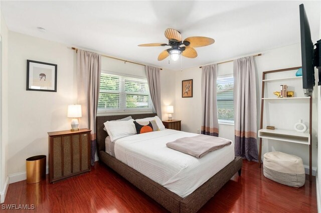 bedroom with baseboards and wood finished floors