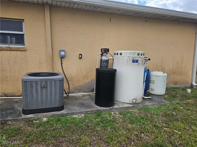 details featuring central air condition unit and stucco siding