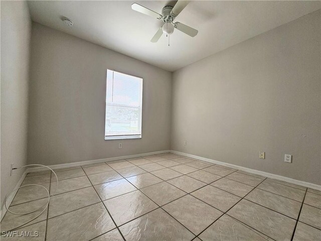 124/126 Ivan Ave S, Lehigh Acres, FL 33973 - empty room featuring light tile patterned flooring, a ceiling fan, and baseboards