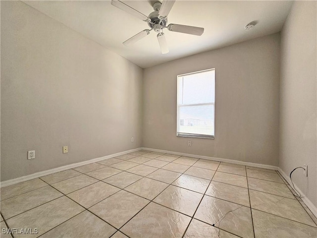 124/126 Ivan Ave S, Lehigh Acres, FL 33973 - empty room featuring light tile patterned flooring, a ceiling fan, and baseboards