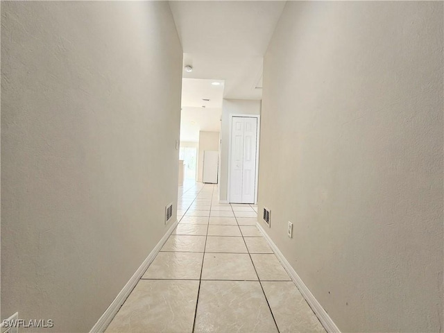 124/126 Ivan Ave S, Lehigh Acres, FL 33973 - hall featuring light tile patterned floors and baseboards