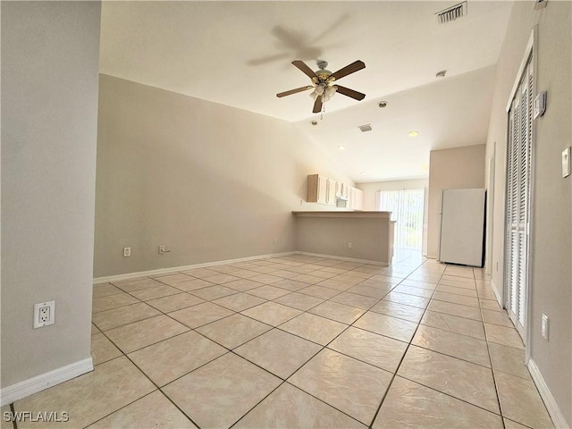 124/126 Ivan Ave S, Lehigh Acres, FL 33973 - spare room with light tile patterned flooring, vaulted ceiling, a ceiling fan, and baseboards
