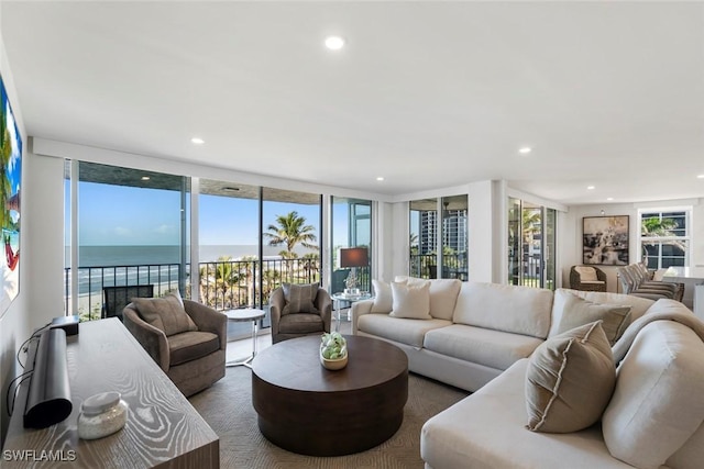 living area with recessed lighting, plenty of natural light, and expansive windows