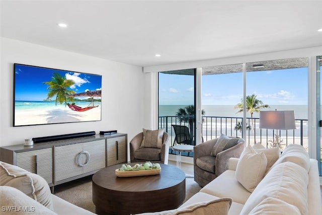 living room with a water view and recessed lighting
