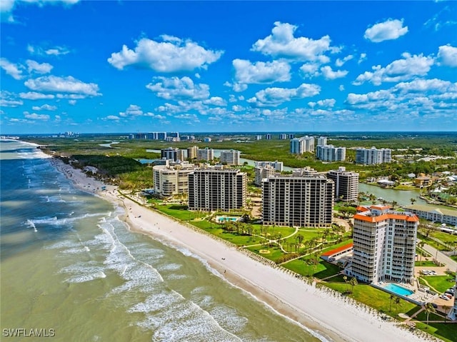 birds eye view of property with a water view, a view of the beach, and a city view