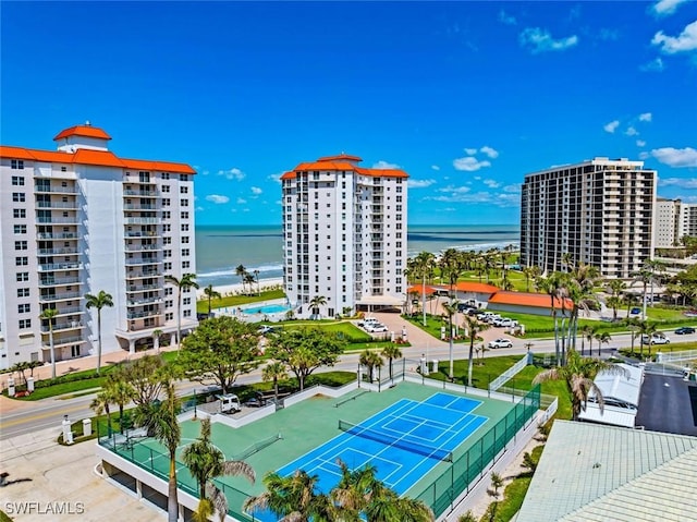 drone / aerial view featuring a city view and a water view