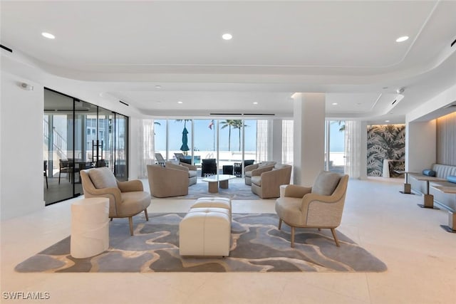 living room with a raised ceiling, tile patterned flooring, and recessed lighting