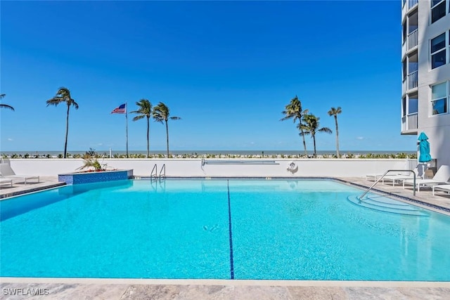 pool with a water view and a patio