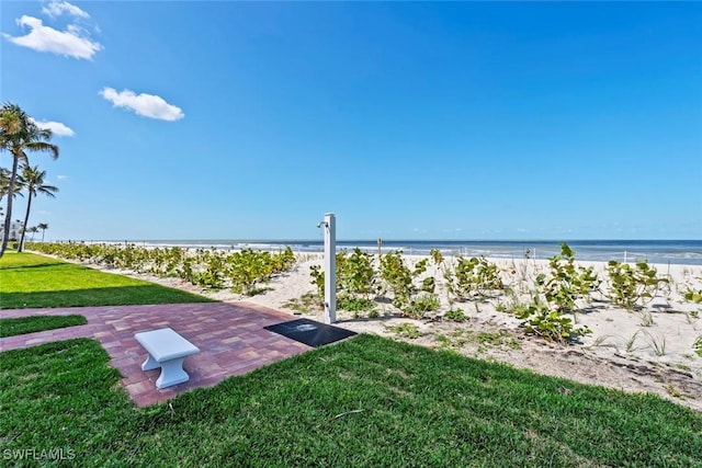 exterior space featuring a patio, a beach view, and a water view