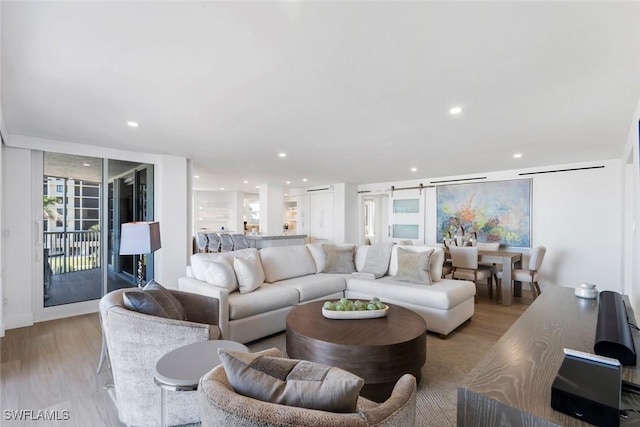 living area with recessed lighting and wood finished floors