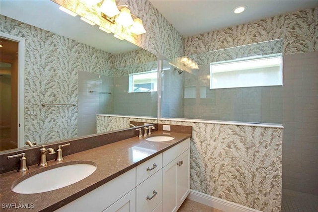 full bathroom with walk in shower and double vanity