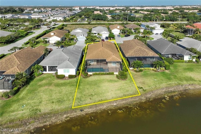 aerial perspective of suburban area with a nearby body of water and property parcel outlined