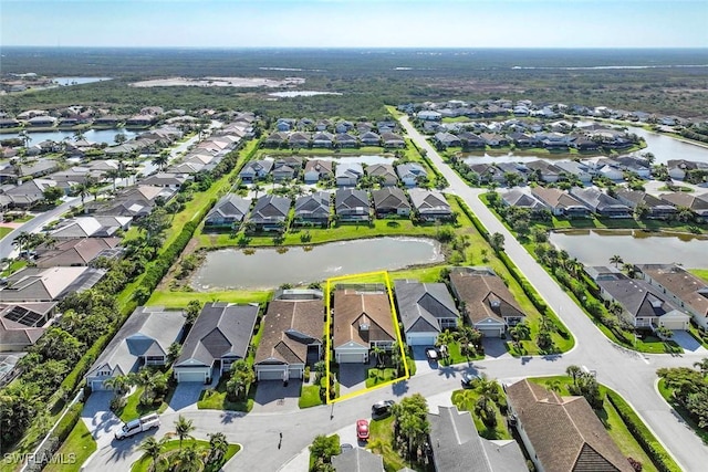 aerial perspective of suburban area featuring property parcel outlined and a nearby body of water