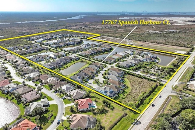 aerial view of residential area featuring a large body of water and property parcel outlined