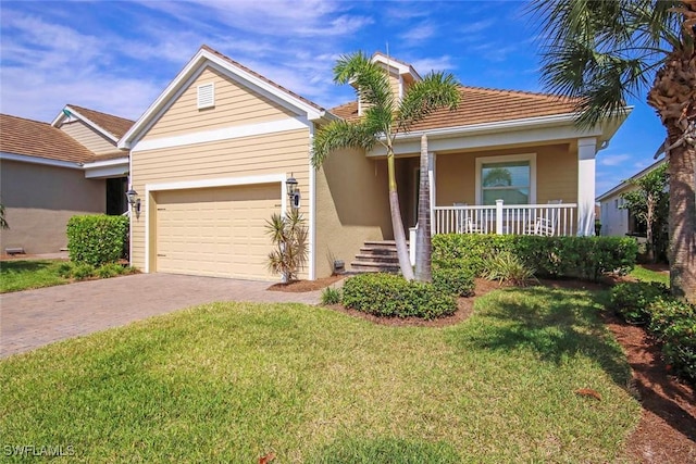ranch-style home featuring driveway, a garage, covered porch, a front yard, and a tile roof