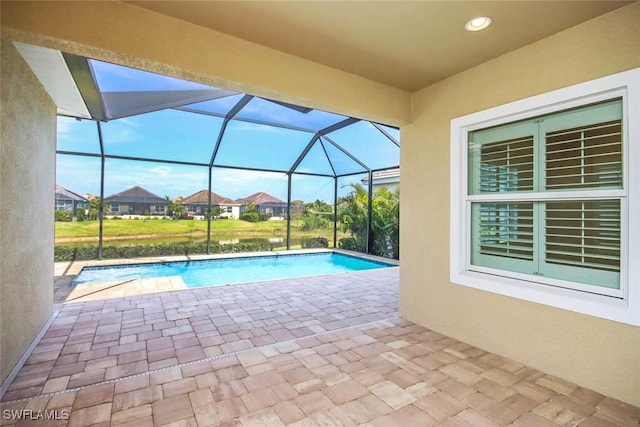 swimming pool featuring a patio and a lanai