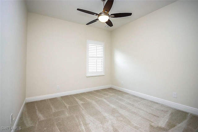 unfurnished room with a ceiling fan, baseboards, and carpet flooring