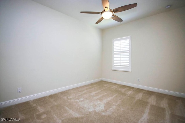 unfurnished room with a ceiling fan, baseboards, carpet, and a smoke detector