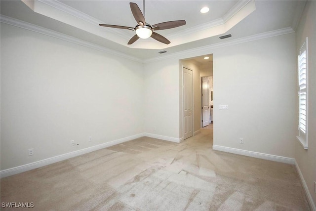 spare room featuring ceiling fan, light carpet, crown molding, a raised ceiling, and recessed lighting