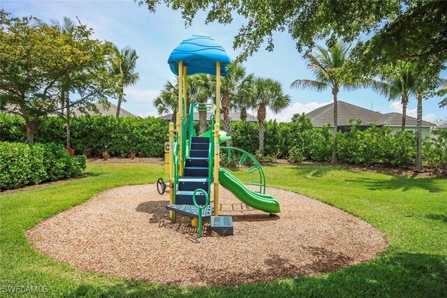 community jungle gym featuring a lawn