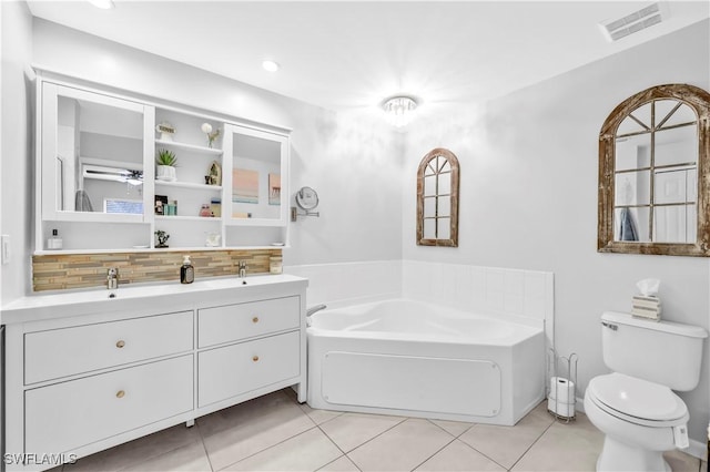 11741 Red Hibiscus Dr, Bonita Springs, FL 34135 - full bathroom with tasteful backsplash, visible vents, toilet, tile patterned flooring, and a garden tub