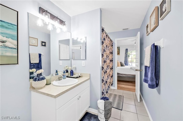 11741 Red Hibiscus Dr, Bonita Springs, FL 34135 - ensuite bathroom featuring tile patterned floors, vanity, baseboards, and connected bathroom