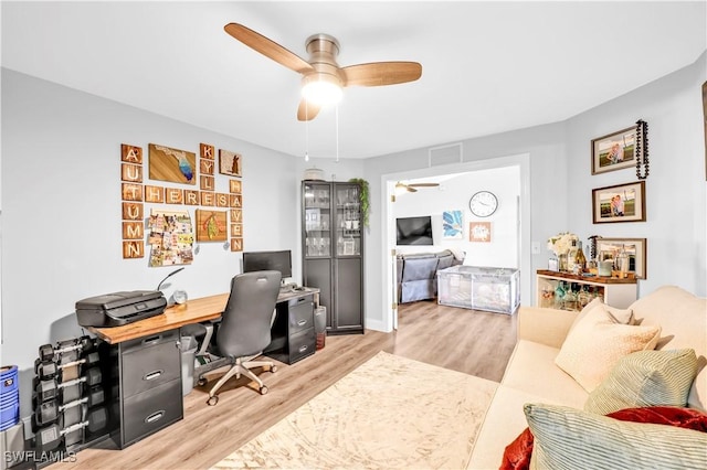11741 Red Hibiscus Dr, Bonita Springs, FL 34135 - home office with light wood-style flooring, a ceiling fan, and visible vents