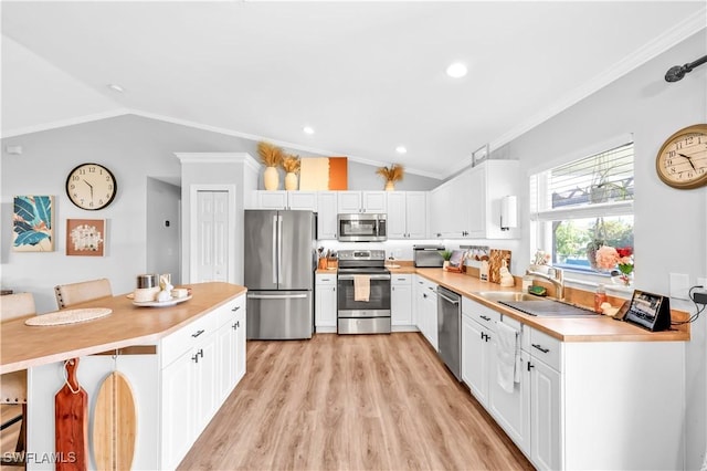 11741 Red Hibiscus Dr, Bonita Springs, FL 34135 - kitchen featuring appliances with stainless steel finishes, a sink, ornamental molding, and lofted ceiling