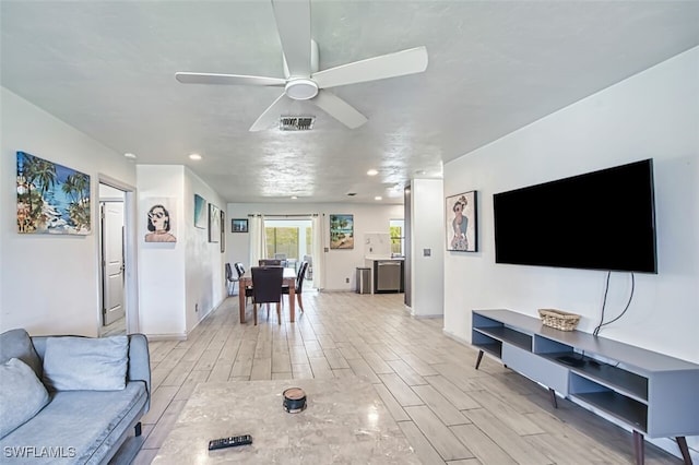 living room featuring visible vents, ceiling fan, wood tiled floor, and recessed lighting