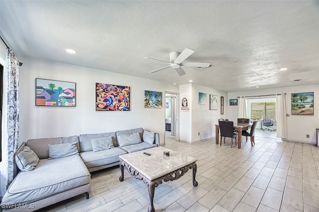 living area featuring recessed lighting, baseboards, a ceiling fan, and wood tiled floor