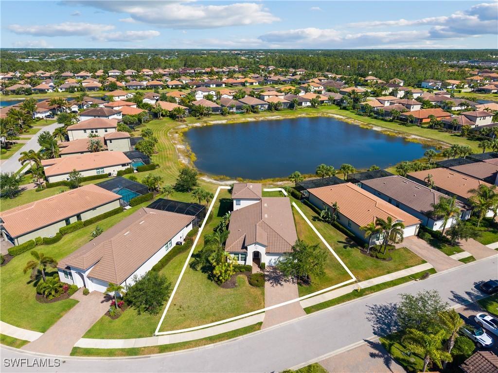 4711 Abaca Cir, Naples, FL 34119 - bird's eye view featuring a water view and a residential view