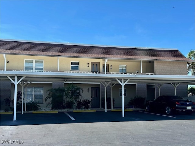1206 SE 46th St Unit 1F, Cape Coral, FL 33904 - rear view of house with covered parking
