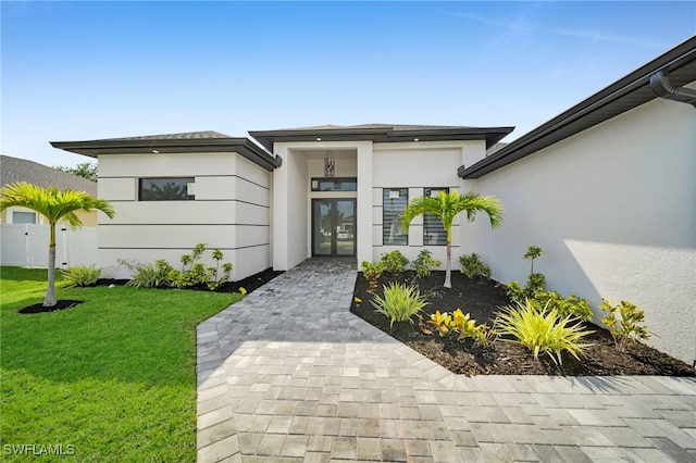 2138 SW 3rd Ave, Cape Coral, FL 33991 - property entrance featuring stucco siding and a lawn