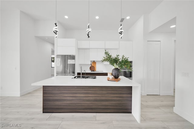 2138 SW 3rd Ave, Cape Coral, FL 33991 - kitchen featuring freestanding refrigerator, modern cabinets, white cabinetry, light countertops, and a kitchen island with sink