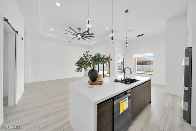 2138 SW 3rd Ave, Cape Coral, FL 33991 - kitchen featuring modern cabinets, dishwashing machine, light countertops, an island with sink, and decorative light fixtures