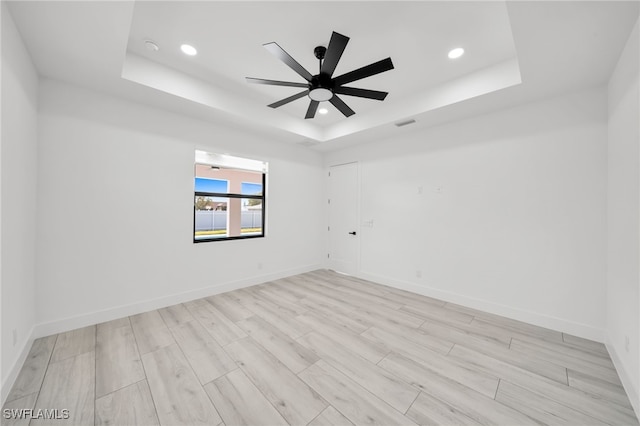 2138 SW 3rd Ave, Cape Coral, FL 33991 - unfurnished room with a raised ceiling, recessed lighting, a ceiling fan, and light wood-style flooring
