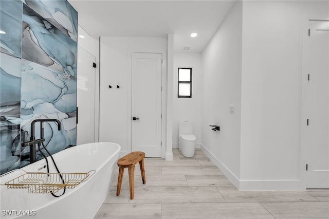 2138 SW 3rd Ave, Cape Coral, FL 33991 - full bath featuring a freestanding tub, recessed lighting, and wood finished floors