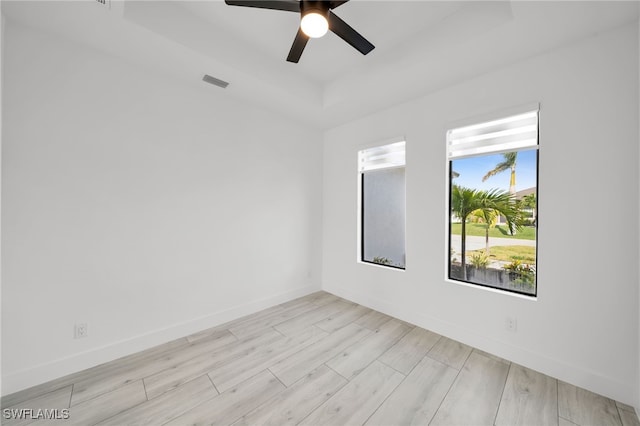 2138 SW 3rd Ave, Cape Coral, FL 33991 - empty room featuring a raised ceiling, wood finished floors, and a ceiling fan
