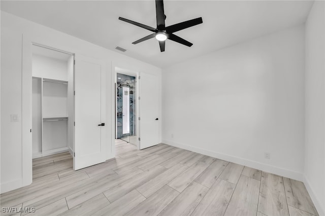 2138 SW 3rd Ave, Cape Coral, FL 33991 - unfurnished bedroom with a spacious closet, wood finished floors, a closet, and ceiling fan