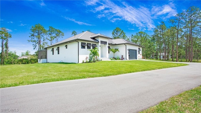2343 Oil Well Rd, Naples, FL 34120 - view of property exterior featuring concrete driveway, a yard, stucco siding, and a garage