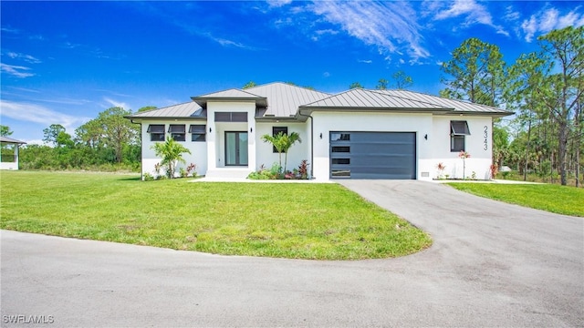 2343 Oil Well Rd, Naples, FL 34120 - prairie-style home with a standing seam roof, metal roof, a front lawn, an attached garage, and driveway
