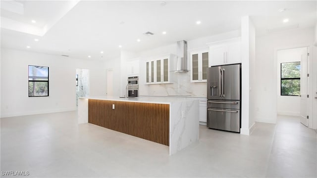 2343 Oil Well Rd, Naples, FL 34120 - kitchen with a center island with sink, appliances with stainless steel finishes, wall chimney exhaust hood, and white cabinetry
