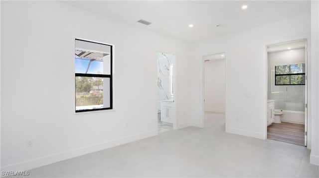 2343 Oil Well Rd, Naples, FL 34120 - unfurnished bedroom with ensuite bath, visible vents, recessed lighting, a walk in closet, and baseboards