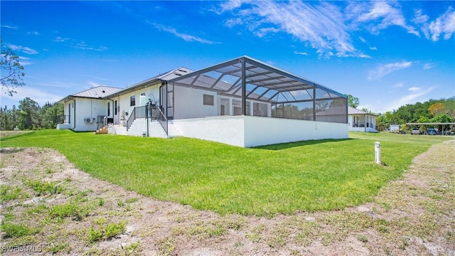 2343 Oil Well Rd, Naples, FL 34120 - back of property featuring a lanai, stucco siding, and a lawn
