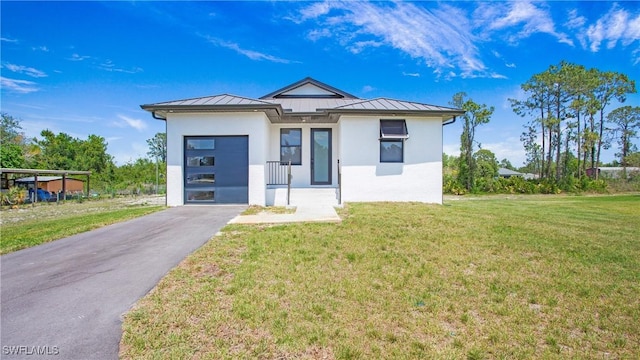 2343 Oil Well Rd, Naples, FL 34120 - view of front of house with stucco siding, a front yard, aphalt driveway, a standing seam roof, and metal roof