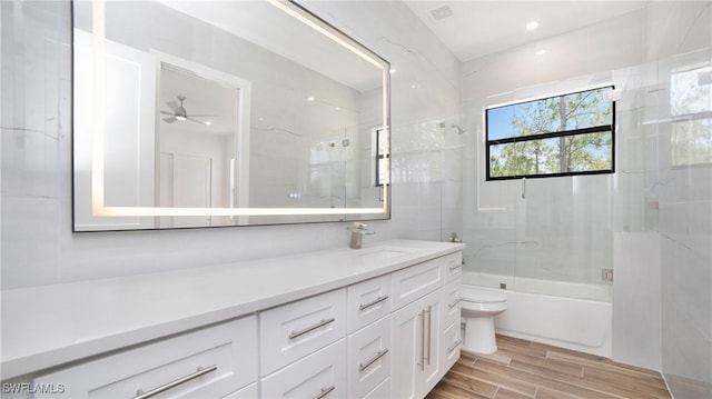 2343 Oil Well Rd, Naples, FL 34120 - full bathroom with shower / bath combination with glass door, vanity, a ceiling fan, toilet, and wood finished floors