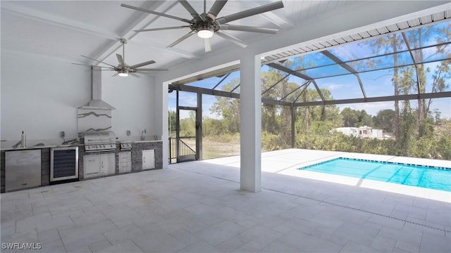 2343 Oil Well Rd, Naples, FL 34120 - pool with exterior kitchen, a patio, grilling area, and a lanai