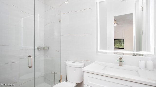 2343 Oil Well Rd, Naples, FL 34120 - full bath featuring toilet, vanity, a ceiling fan, and a stall shower