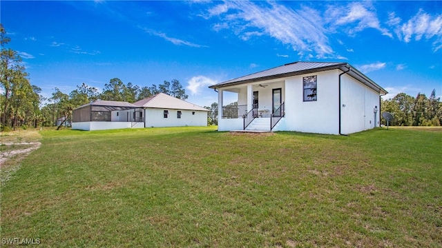 2343 Oil Well Rd, Naples, FL 34120 - rear view of house with a yard, a porch, ceiling fan, and stucco siding