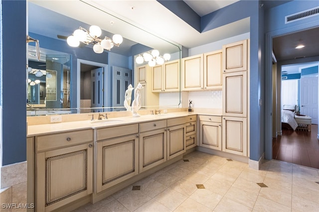 14270 Royal Harbour Ct Unit 323, Fort Myers, FL 33908 - ensuite bathroom with a chandelier, double vanity, and tile patterned floors